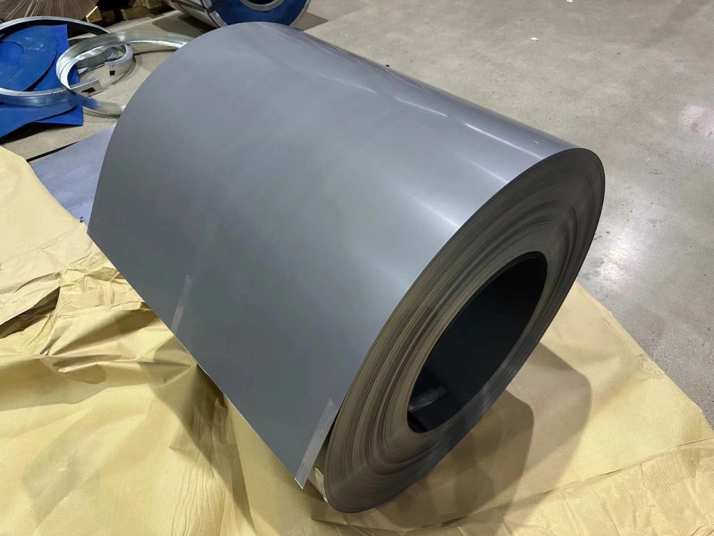 Silicon Coil and Silicon Steel Explained: Key Uses in Modern Industry-1-Sunrise New Material The image shows a large rolled coil of gray metal sheet placed on protective paper in an industrial setting